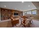 A finished basement offers a comfortable seating area and custom bookshelves at 15789 W 95Th Pl, Arvada, CO 80007