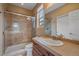 Bathroom showcasing glass shower, tile surround, vanity, and neutral earth tones at 15789 W 95Th Pl, Arvada, CO 80007