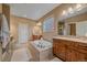 Luxurious bathroom featuring a soaking tub, dual vanities, and a walk-in shower at 15789 W 95Th Pl, Arvada, CO 80007