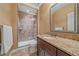 Bathroom featuring a glass shower, vanity with a granite countertop, and an ornate mirror at 15789 W 95Th Pl, Arvada, CO 80007