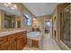 Large bathroom featuring a soaking tub, dual vanities, and a walk-in shower at 15789 W 95Th Pl, Arvada, CO 80007