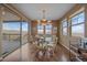 Bright dining room features hardwood floors, a chandelier, and a sliding glass door leading to an outdoor deck at 15789 W 95Th Pl, Arvada, CO 80007