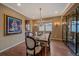 Formal dining room with chandelier, wood floors, and glass display cabinet at 15789 W 95Th Pl, Arvada, CO 80007