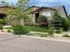 Inviting single-story home with lush front yard landscaping including decorative rocks, mature trees, and colorful flowers at 15789 W 95Th Pl, Arvada, CO 80007