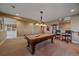 Finished basement game room featuring a billiard table and classic design elements at 15789 W 95Th Pl, Arvada, CO 80007