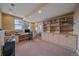 Bright home office features built-in shelves, carpet, and a large desk area at 15789 W 95Th Pl, Arvada, CO 80007