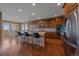 Spacious kitchen with stainless steel appliances, dark wood floors, and an island with bar seating at 15789 W 95Th Pl, Arvada, CO 80007