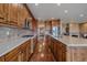 Gourmet kitchen with wood cabinetry, stone countertops, and stainless steel appliances at 15789 W 95Th Pl, Arvada, CO 80007