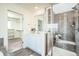 Bathroom with a glass-enclosed shower with bench seating, a vanity, and a walk-in closet at 9607 Williamsburg St, Littleton, CO 80125