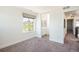 Carpeted bedroom with a view into the ensuite bathroom at 9607 Williamsburg St, Littleton, CO 80125