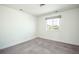 Carpeted bedroom featuring a large window with gray shades for natural lighting at 9607 Williamsburg St, Littleton, CO 80125