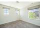Bedroom with three windows featuring gray shades and carpeted floors at 9607 Williamsburg St, Littleton, CO 80125