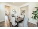 Dining room features a dark wood table, six chairs, artwork, and hardwood floors at 9607 Williamsburg St, Littleton, CO 80125