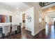 Open-concept dining room featuring dark hardwood floors and an adjacent staircase at 9607 Williamsburg St, Littleton, CO 80125
