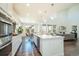 Bright, modern kitchen with stainless steel appliances, a spacious island, and hardwood floors at 9607 Williamsburg St, Littleton, CO 80125