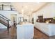 Spacious kitchen featuring an island with seating, white cabinets, and stainless steel appliances at 9607 Williamsburg St, Littleton, CO 80125