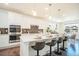 Modern kitchen with stainless steel appliances, island with seating, and ample white cabinetry at 9607 Williamsburg St, Littleton, CO 80125