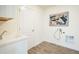 Laundry room with white cabinetry, sink, tile floors, and a washer hookup at 9607 Williamsburg St, Littleton, CO 80125