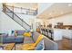 Open-concept living space with a modern kitchen and a staircase leading to the second floor at 9607 Williamsburg St, Littleton, CO 80125