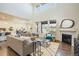 Bright and airy living room with large windows, a fireplace, and hardwood floors at 9607 Williamsburg St, Littleton, CO 80125