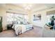 Spacious main bedroom with tray ceilings, large windows, and stylish furnishings at 9607 Williamsburg St, Littleton, CO 80125