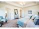 Serene main bedroom featuring soft colors, large windows, and a cozy seating area at 9607 Williamsburg St, Littleton, CO 80125