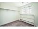 Carpeted walk-in closet with shelving and two windows providing ample natural light at 9607 Williamsburg St, Littleton, CO 80125