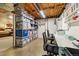 Well-organized basement features extensive shelving for storage, workspace, and potential living area at 1211 S Zuni St, Denver, CO 80223