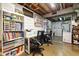 Organized basement space features shelving, desks, and laundry area, offering versatile functionality at 1211 S Zuni St, Denver, CO 80223