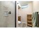 Bathroom featuring a tiled shower with glass doors, a wood vanity, and a toilet at 1211 S Zuni St, Denver, CO 80223