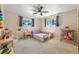 Light-filled bedroom with neutral walls, carpet flooring, ceiling fan, and window at 1211 S Zuni St, Denver, CO 80223