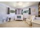 Cozy Bedroom with soft lavender walls, white crib, patterned curtains, and carpet at 1211 S Zuni St, Denver, CO 80223