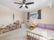 Bright bedroom featuring natural wood furnishings, neutral walls and carpet, and a ceiling fan at 1211 S Zuni St, Denver, CO 80223