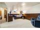 Basement bedroom featuring wood paneled walls, a full bed, and a comfortable sitting chair at 1211 S Zuni St, Denver, CO 80223