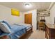 Bedroom featuring light walls, a double closet, a work station, and carpeted floors at 1211 S Zuni St, Denver, CO 80223
