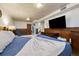 Basement bedroom featuring wood paneled walls, a full bed, and a large television at 1211 S Zuni St, Denver, CO 80223