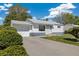 Inviting single story home with a well manicured lawn and an attached garage at 1211 S Zuni St, Denver, CO 80223
