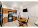 Eat-in kitchen featuring a wooden table and appliances at 1211 S Zuni St, Denver, CO 80223
