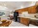 Bright kitchen showcases oak cabinets, white countertops, black appliances, and tile flooring at 1211 S Zuni St, Denver, CO 80223