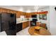 Well-lit eat-in kitchen featuring a wooden table and appliances at 1211 S Zuni St, Denver, CO 80223