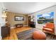 Bright living room with hardwood floors, large window, and stylish furniture at 1211 S Zuni St, Denver, CO 80223