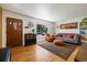 Bright living room featuring hardwood floors, modern decor, and a large picture window at 1211 S Zuni St, Denver, CO 80223