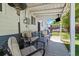 Covered outdoor patio featuring comfortable seating, a mounted TV, and a view of the backyard at 1211 S Zuni St, Denver, CO 80223