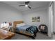 Cozy bedroom with neutral walls and modern furnishings, including a wooden bed frame and stylish chair at 1750 Wewatta St # 605, Denver, CO 80202