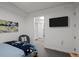 A well-lit bedroom showcasing a stylish bed, accent chair, and access to a spacious walk-in closet at 1750 Wewatta St # 605, Denver, CO 80202