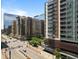 A scenic street view is dominated by modern apartment buildings, a Whole Foods Market, and pedestrian activity at 1750 Wewatta St # 605, Denver, CO 80202