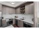 Modern kitchen featuring stainless steel appliances and grey cabinetry at 1750 Wewatta St # 605, Denver, CO 80202