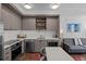 Kitchen featuring stainless steel appliances and grey cabinetry at 1750 Wewatta St # 605, Denver, CO 80202