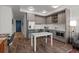 A stylish kitchen is featured with stainless steel appliances, custom cabinets, and a dining area at 1750 Wewatta St # 605, Denver, CO 80202