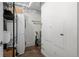 Efficient laundry room with a stacked washer and dryer, utility sink, and storage options at 1750 Wewatta St # 605, Denver, CO 80202